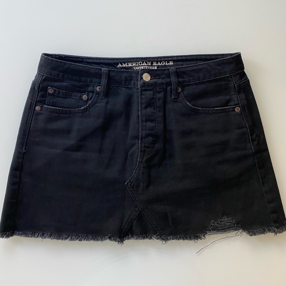 Distressed black denim mini skirt